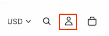 The right end of the sample storefront's header, with a USD currency selector, a search icon, the Account icon outlined in red, and a cart icon.